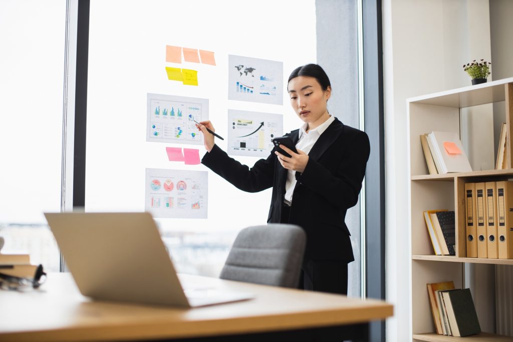 Asian businesswoman presenting data in modern office setting
